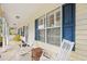 Covered front porch featuring rocking chairs, blue shutters, and outdoor seating at 106 Willow Ridge Rd., Myrtle Beach, SC 29588