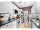 Well-lit kitchen features ample white cabinetry, stainless steel appliances, and dark countertops at 106 Willow Ridge Rd., Myrtle Beach, SC 29588