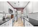 Well-lit kitchen features ample white cabinetry, stainless steel appliances, and dark countertops at 106 Willow Ridge Rd., Myrtle Beach, SC 29588