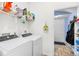 Functional laundry room with modern washer and dryer, shelving, and access to hallway at 106 Willow Ridge Rd., Myrtle Beach, SC 29588