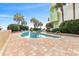 Outdoor pool area featuring a uniquely shaped pool, lounge chairs, palm trees, and lush landscaping at 1105 S Ocean Blvd. # 630, Myrtle Beach, SC 29577