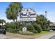 Well-maintained resort signage amidst lush landscaping, showcasing accolades and amenities for potential visitors at 1105 S Ocean Blvd. # 630, Myrtle Beach, SC 29577