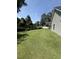 Large, well-manicured backyard with an expansive lawn and privacy landscaping, perfect for outdoor activities at 113 Edwards Ln., Longs, SC 29568