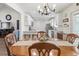 A view of the kitchen from the dining room shows an airy kitchen with white cabinets at 113 Edwards Ln., Longs, SC 29568