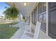 Long, covered front porch featuring white columns and rocking chairs, great for enjoying the outdoors at 113 Edwards Ln., Longs, SC 29568