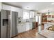 Modern kitchen features stainless steel appliances, white cabinetry, granite countertops, and hardwood floors at 113 Edwards Ln., Longs, SC 29568