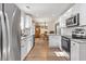 Modern kitchen featuring white cabinets, stainless steel appliances, marble countertops, and natural light at 113 Edwards Ln., Longs, SC 29568