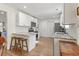 Modern kitchen with stainless steel appliances, white cabinets, and a breakfast bar with seating at 113 Edwards Ln., Longs, SC 29568