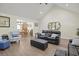 Bright and airy living room with hardwood floors seamlessly connects to the dining area at 113 Edwards Ln., Longs, SC 29568