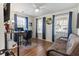 Well-lit office space featuring hardwood floors, a ceiling fan, and large windows with nice curtains and decor at 113 Edwards Ln., Longs, SC 29568