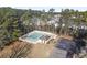Aerial view of a community pool surrounded by lush trees and a parking lot at 113 Edwards Ln., Longs, SC 29568