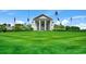 Grand clubhouse with white columns, flags, and manicured lawn at 116 Cypress Point Ct. # 302, Myrtle Beach, SC 29579