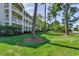 Three story building with well-maintained landscaping and multiple balconies overlooking the surrounding scenery at 116 Cypress Point Ct. # 302, Myrtle Beach, SC 29579