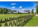 Lush golf course with a wooden fence and green trees under a blue sky at 116 Cypress Point Ct. # 302, Myrtle Beach, SC 29579