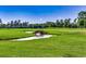Scenic golf course view with a stone bridge over a creek on a sunny day at 116 Cypress Point Ct. # 302, Myrtle Beach, SC 29579