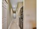 Well-lit hallway with wood floors, storage closets, and a stylish black cabinet at 116 Cypress Point Ct. # 302, Myrtle Beach, SC 29579