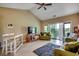 Inviting living room featuring a high ceiling, a ceiling fan, and a sliding glass door to a balcony at 116 Cypress Point Ct. # 302, Myrtle Beach, SC 29579