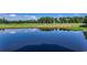 Scenic pond with still water reflecting the golf course and sky, creating a serene atmosphere at 116 Cypress Point Ct. # 302, Myrtle Beach, SC 29579