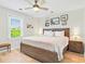 Bedroom with ceiling fan, wood floors, and natural light from a window at 118 Seaside St., Holden Beach, NC 28462
