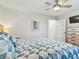 Comfortable bedroom featuring a neatly made bed and a rustic wooden dresser with a mirror at 118 Seaside St., Holden Beach, NC 28462