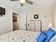 Bedroom featuring light walls, a ceiling fan, light wood flooring, and coastal accents at 118 Seaside St., Holden Beach, NC 28462