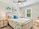 Bedroom featuring wood floors, a ceiling fan, and light walls with a window at 118 Seaside St., Holden Beach, NC 28462