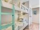 Bunk room with beds, wood-look flooring, and coastal accents at 118 Seaside St., Holden Beach, NC 28462