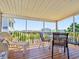 Spacious screened-in deck with comfortable seating offering great views of the surrounding neighborhood at 118 Seaside St., Holden Beach, NC 28462
