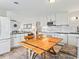 Cozy dining area with a large table, white cabinets, and open access to the adjacent living space at 118 Seaside St., Holden Beach, NC 28462