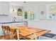 Bright eat in dining area with a large table, and a view of the kitchen area at 118 Seaside St., Holden Beach, NC 28462