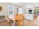 Eat in dining area featuring wood floors, view to the outside and white trim at 118 Seaside St., Holden Beach, NC 28462
