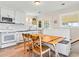 Bright eat in dining area with a large table, and a view of the kitchen area at 118 Seaside St., Holden Beach, NC 28462