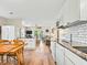 Bright, open-concept kitchen featuring white cabinets, modern appliances, and seamless flow into the inviting living area at 118 Seaside St., Holden Beach, NC 28462