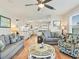 Open-concept living room and kitchen with hardwood floors and bright, neutral decor at 118 Seaside St., Holden Beach, NC 28462
