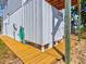 Outdoor shower area with wood flooring, ready for rinsing off after beach activities at 118 Seaside St., Holden Beach, NC 28462