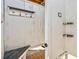 Clean outdoor shower area with a bench, hooks, and shelves for convenience at 118 Seaside St., Holden Beach, NC 28462