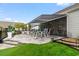 Paver patio with a grill, fire pit, awning, and turfed side yard at 1211 Arezzo Ave., Myrtle Beach, SC 29572