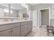 Bathroom with double vanity, tile floors, quartz countertops, and stainless steel fixtures at 1211 Arezzo Ave., Myrtle Beach, SC 29572