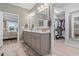 En-suite bathroom featuring double vanity, marble countertops, and an entrance to walk-in closet at 1211 Arezzo Ave., Myrtle Beach, SC 29572