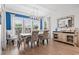 Bright dining room featuring a stylish light fixture and neutral decor with large windows at 1211 Arezzo Ave., Myrtle Beach, SC 29572