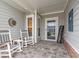 Cozy front porch featuring rocking chairs, decorative accessories, and a welcoming entrance at 1211 Arezzo Ave., Myrtle Beach, SC 29572