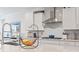 Bright kitchen featuring granite countertops, stainless steel appliances, and white cabinetry with a decorative backsplash at 1211 Arezzo Ave., Myrtle Beach, SC 29572