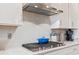 Elegant kitchen with gas range, custom backsplash, and white cabinetry at 1211 Arezzo Ave., Myrtle Beach, SC 29572