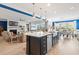 Open-concept kitchen with a large island and stainless steel appliances flowing into the living and dining area at 1211 Arezzo Ave., Myrtle Beach, SC 29572