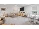 Spacious living room with a large television, sofa, and hardwood floors at 1211 Arezzo Ave., Myrtle Beach, SC 29572