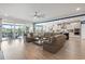Expansive living room that features a connected kitchen, a fireplace, comfortable sofas, and access to a screened in patio at 1211 Arezzo Ave., Myrtle Beach, SC 29572