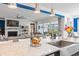 Open-concept living space features large windows, a fireplace, and kitchen access at 1211 Arezzo Ave., Myrtle Beach, SC 29572