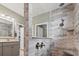 Tiled shower with a glass enclosure, rainfall shower head, and built-in bench seating at 1211 Arezzo Ave., Myrtle Beach, SC 29572