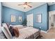 Bright bedroom featuring stylish twin beds, ceiling fan, and coastal décor at 127 Emerald Rush Ct., Longs, SC 29568