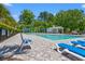 Community pool area with lounge chairs and umbrellas, perfect for relaxation and recreation at 127 Emerald Rush Ct., Longs, SC 29568